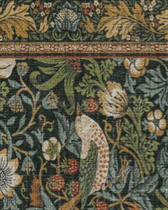 an intricately designed rug with birds and flowers on it's border, in green tones