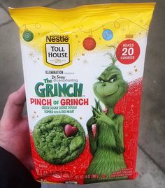 someone holding up a bag of the grinch snack