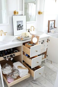 a bathroom with two sinks and drawers in it