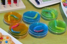 several plastic containers filled with different types of candy and cookies on top of a table