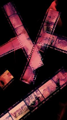 some film strips are stacked up in the shape of a x on top of each other