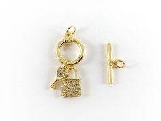 These cute little round circle toggles are real gold 18K plated with a copper base. These toggles can be wonderful made into bracelets, dainty necklaces and even used for crafts. 1 set for $6.99 3 sets for $16.99 Material: Micro pave CZ, Real gold 18K plated with copper base Size: Circle - Around 13mm Stick - Around 18mm These toggles are slow tarnish and are suitable for everyday wear. For longer lasting, please avoid contact with perfumes, body oils, and other chemicals, including household cl Gold-tone Jewelry With Toggle Clasp, Round Gold-plated Jewelry With Toggle Clasp, Gold Toggle Necklace With Spring Ring Clasp As Gift, Dainty Gold Toggle Necklace With Lobster Clasp, Gold Toggle Necklace With Charms As Gift, Adjustable Yellow Gold Toggle Necklace Gift, Gold Dainty Toggle Necklace With Clasp, Gold Jewelry With Round Pendant And Toggle Clasp, Gold Dainty Toggle Necklace