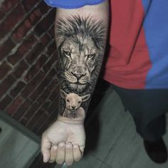 a man with a lion and lamb tattoo on his arm