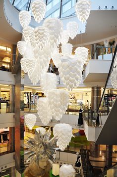 a large chandelier hanging from the ceiling in a shopping mall