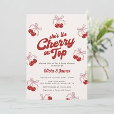 the cherry on top baby shower is displayed in front of a vase with white flowers