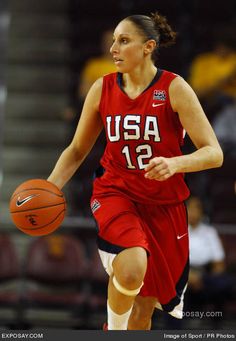 a female basketball player dribbling the ball during a game