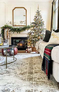 a living room decorated for christmas with a fireplace