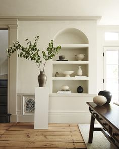 a living room filled with furniture and vases