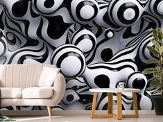 a living room with black and white designs on the wall