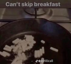 a frying pan filled with marshmallows on top of a stove