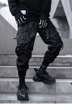 Unleash your streetwear charisma with our black Men's Technical Joggers. Presenting the pinnacle of urban attire, our Technical Joggers, where style and functionality unite to elevate your wardrobe. Envision yourself confidently striding through the bustling city streets, exuding an air of sophistication and modernity that sets you apart from the crowd. As you don these cutting-edge pants, you'll feel an instant transformation into an enigmatic Harajuku hipster with an unwavering sense of fashion. The innovative elastic waistband features a tactical buckle, ensuring a perfect fit while maintaining an aura of urban mystique. These black, intimidating joggers instantly amplify your streetwear charisma, seamlessly integrating with darkwear or warcore pieces. The multiple stylish black cargo p Techwear Men Outfit, 2023 Pants, Mens Techwear, Best Cargo Pants, Techwear Men, Casual Techwear, Apocalyptic Clothing, Techwear Jacket, Streetwear Cargo Pants