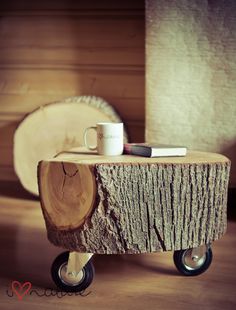 a wooden table topped with a coffee cup on top of a wooden wheelbarrow