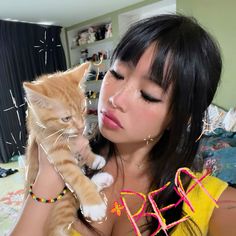 a woman holding a cat up to her face with the caption befrie