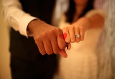 a man and woman holding hands while wearing wedding rings on their fingers with the words love written in korean