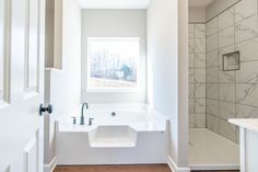 a bathroom with a sink, tub and shower