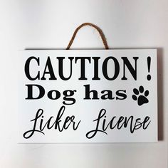 a sign that says caution dog has licker license