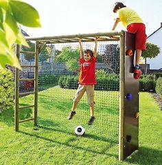 two children are playing on a soccer goal