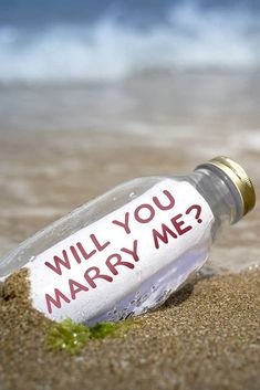 a message in a bottle that says will you marry me?