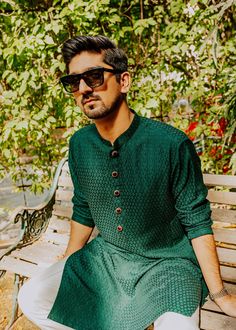 Elevate your style with a Castleton green raw silk kurta and pajama set, perfect for weddings and special occasions. Explore a range of options, including designer, traditional, and embroidered kurta shalwar, tailored to perfection for men.In the realm of men's attire, a mesmerizing hue of castleton green karandi fabric takes center stage, its allure further enhanced by the exquisite craftsmanship displayed in the hand-made buttons. These buttons, adorned with faux ruby stones meticulously embed Dark Green Kurta Men, Mehendi Outfits For Men, Green Kurta Men, Castleton Green, Kurta Designs Men's, Indian Menswear, Mehendi Dress, Raw Silk Kurta, Pakistani Wear