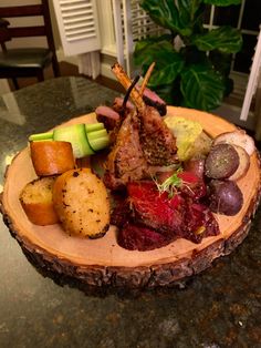 a plate with meat, potatoes and vegetables on it