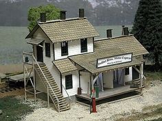 a model house with a porch and steps leading up to the front door that is on display