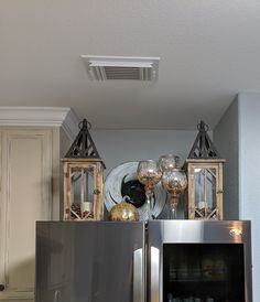 a metallic refrigerator freezer sitting inside of a kitchen