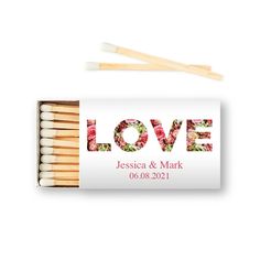 matches with the word love printed on it and two matches in front of them, next to each other