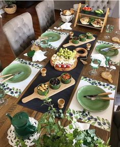 the table is set with green dishes and plates