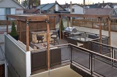 an outdoor deck with grill and seating area