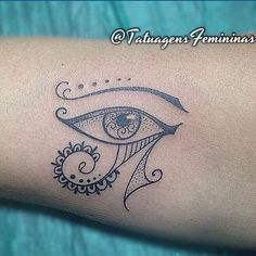 a woman's arm with an eye tattoo on it