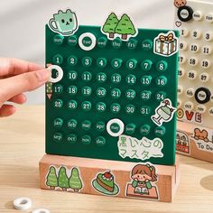 a wooden calendar with stickers on it