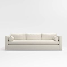 a white couch sitting on top of a white floor