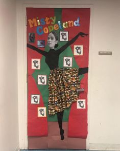 a door decorated with an image of a woman wearing a skirt and holding her arms in the air