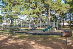 an empty playground in the middle of a park