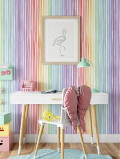 a room with a desk, chair and wallpaper in pastel colors on the walls