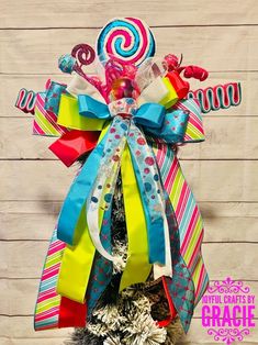 a colorful christmas tree topper with candy canes and candies in the center