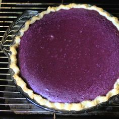 a purple pie sitting on top of a metal rack