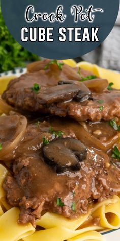 a plate with meat and mushroom sauce on top of noodles, garnished with parsley