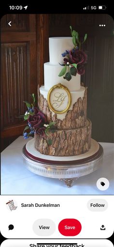 a three tiered wedding cake with flowers on the top and initials on the side