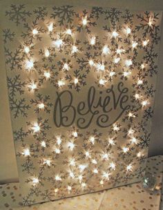 lighted christmas canvas with believe written on it