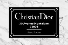 a black and white business card with the words christian dior on it's side