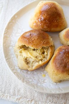 three gluten - free dinner rolls on a white plate with text overlay