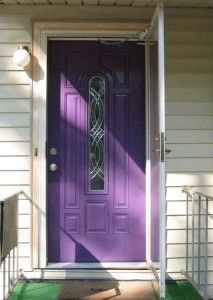 a purple front door on a white house