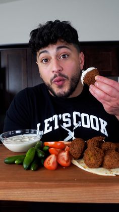 a man is eating some food on a plate with vegetables and sauce in front of him