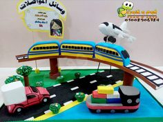 a cake that is shaped like a train and cars on the tracks with an airplane in the background