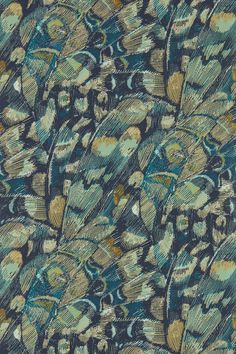 a blue and green fabric with lots of feathers on it