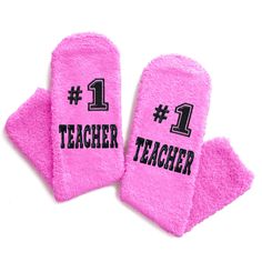 two pink mitts with the number 1 and one for teacher written in black on them