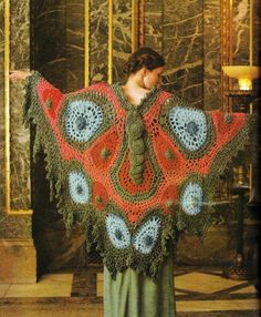 a woman wearing a red and blue crocheted shawl