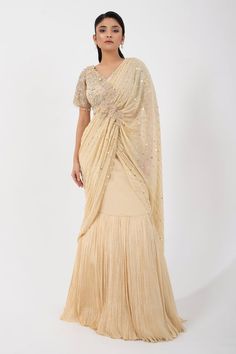 Gold pleated pre-draped skirt saree featuring attached sequin bead embellished pallu with applique and attached can can. Comes with bead embellished floral padded blouse. - Aza Fashions Elegant V-neck Lehenga With Zari Work, Elegant V-neck Pre-draped Saree For Festive Occasions, Draped Georgette Dress With Sheer Dupatta, Elegant Draped Semi-stitched Sharara, Elegant Lehenga With Zari Work And V-neck, Designer Draped Dress With Zari Work, Elegant Draped Sharara For Diwali, Elegant Draped Sharara For Receptions, Designer Wear Pre-draped Saree With V-neck And Unstitched Blouse