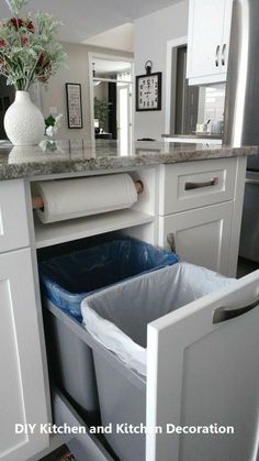 a kitchen with an open trash can in it